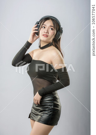 young beautiful asian woman with headphones 106577841