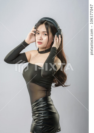 young beautiful asian woman with headphones 106577847