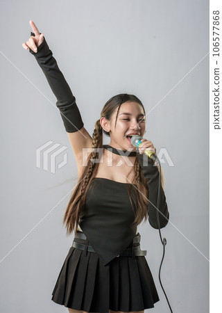 young beautiful asian woman with headphones 106577868