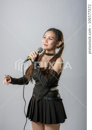 young beautiful asian woman with headphones 106577872