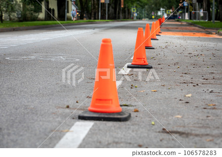 Orange traffic cones on the road. Urban environment 106578283