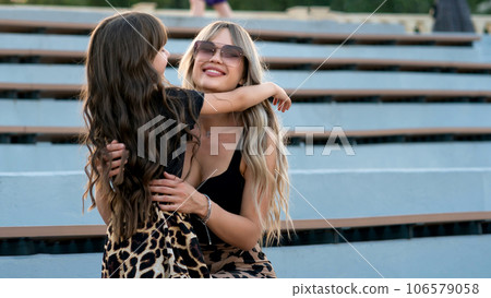 Mom hugs little daughter for a walk Mom hugs little daughter for a walk 106579058