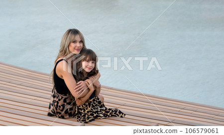Mom hugs little daughter for a walk Mom hugs little daughter for a walk 106579061