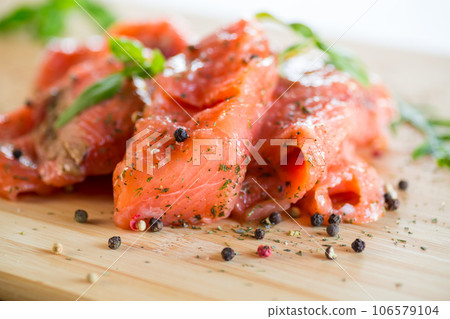 Fresh big pieces of salted red fish with spices and herbs . Fresh big pieces of salted red fish with spices and herbs . 106579104