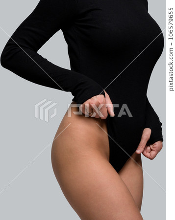Female body in black bodysuit. Smooth skin in bikini area Female body in black bodysuit. Smooth skin in bikini area 106579655