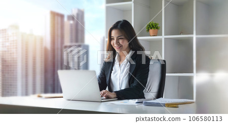 Asian businesswoman working with laptop in office. business financial concept Asian businesswoman working with laptop in office. business financial concept 106580113