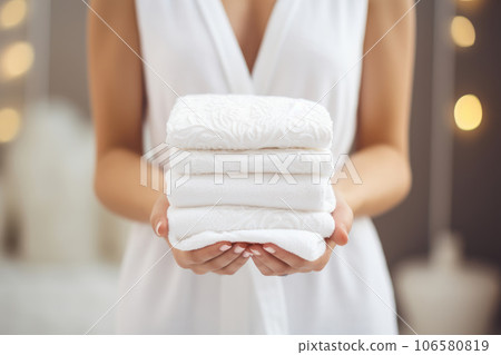 A woman holds white towels A woman holds white towels 106580819