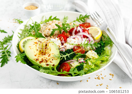 Oatmeal porridge with avocado, cottage cheese, tomatoes, fresh green salad and arugula. Healthy breakfast. Top view Oatmeal porridge with avocado, cottage cheese, tomatoes, fresh green salad and arugula. Healthy breakfast. Top view 106581253