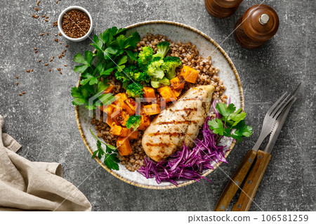 Grilled chicken breast with buckwheat, roasted butternut squash, broccoli, fresh greens and red cabbage. Healthy food, lunch menu, top view 106581259