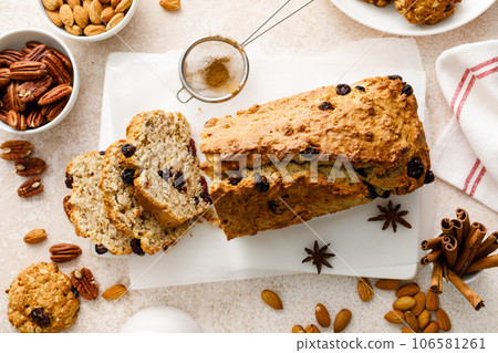Fruitcake with cranberry, almond and pecan nuts sliced on a wooden board Fruitcake with cranberry, almond and pecan nuts sliced on a wooden board 106581261