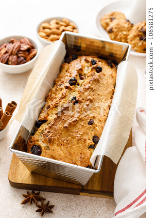 Fruitcake with cranberry, almond and pecan nuts in baking form Fruitcake with cranberry, almond and pecan nuts in baking form 106581275