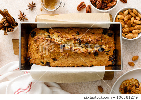 Fruitcake with cranberry, almond and pecan nuts in baking form 106581279