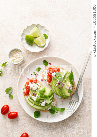 Avocado toast with cheese cottage, tomato and herbs for breakfast 106581300