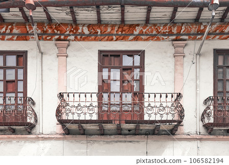 Street view of the facade of an old colonial building, Cuenca, Ecuador. 106582194