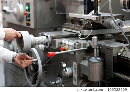 engineer setting up metalworking lathe engineer setting up metalworking lathe 106582369