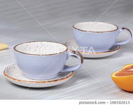 Empty ceramic blue cups with saucers on a gray background. 106582613
