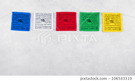 Colorful Tibetan buddhist prayer flags by Nepal on a grey background, copy space 106583319