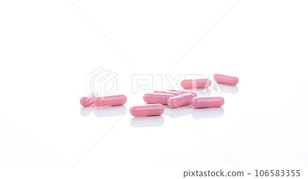 Pink capsule pills on white background. Pharmaceutical industry. Vitamins, minerals, and supplements concept. Pharmacy products. Pharmaceutical medicine. Prescription drugs. Healthcare and medicine. 106583355