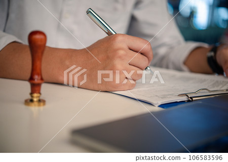 Hand Signing a Contract with Pen. business, finance, or legal projects, formal agreements and partnerships. 106583596