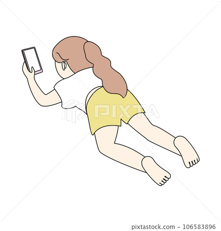A girl lying on her stomach and using a smartphone A girl lying on her stomach and using a smartphone 106583896