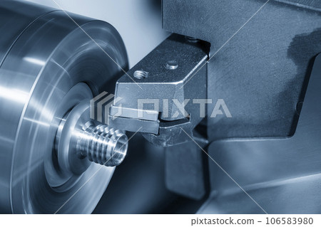 Close up scene the CNC lathe machine thread cutting at the end of metal pipe parts. 106583980