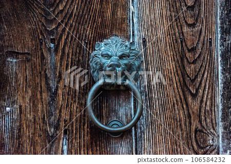 Old-fashioned door knocker in shape of a lion head somewhere on a door in downtown Matera, Southern Italy Old-fashioned door knocker in shape of a lion head somewhere on a door in downtown Matera, Southern Italy 106584232