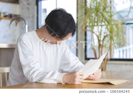 A man troubled watching a document 106584245