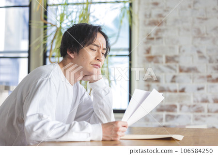 A man troubled watching a document A man troubled watching a document 106584250