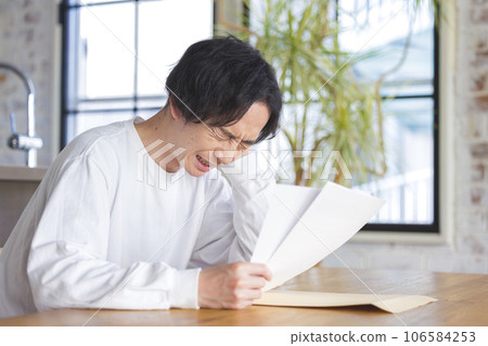 A man troubled watching a document A man troubled watching a document 106584253