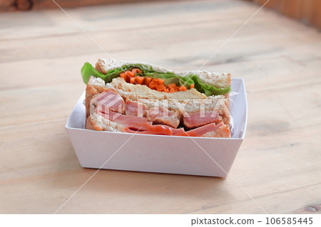 Sandwich with ham, cheese, tomatoes, and toasted bread. 106585445
