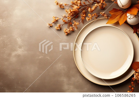 Thanksgiving day table setting decorated fallen leaves, beige flowers in natural colors. 106586265