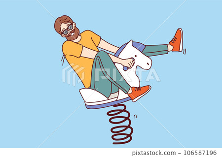 Playful man sits on wooden rocking horse and enjoys children games, behaves like child adolescence Playful man sits on wooden rocking horse and enjoys children games, behaves like child adolescence 106587196