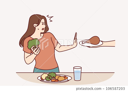 Vegetarian woman refuses meat and makes stop gesture in fear while eating fresh vegetables Vegetarian woman refuses meat and makes stop gesture in fear while eating fresh vegetables 106587203