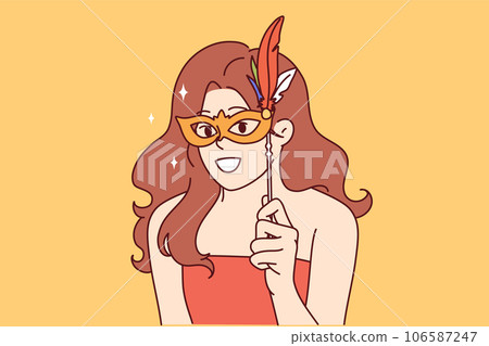 Woman puts feathered carnival mask on face to participate in masquerade party and remain incognito Woman puts feathered carnival mask on face to participate in masquerade party and remain incognito 106587247