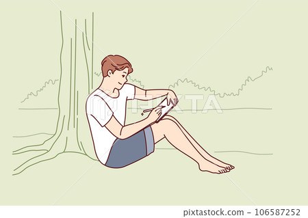 Man draws in electronic tablet sitting on shore of lake and enjoying landscape of morning nature Man draws in electronic tablet sitting on shore of lake and enjoying landscape of morning nature 106587252