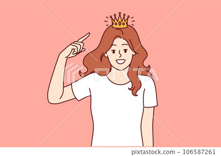 Woman with golden crown on head, smiling and looking at screen, showing confidence and narcissism 106587261