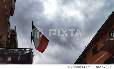 Italian flag on the balcony, in cloudy weather 106587427