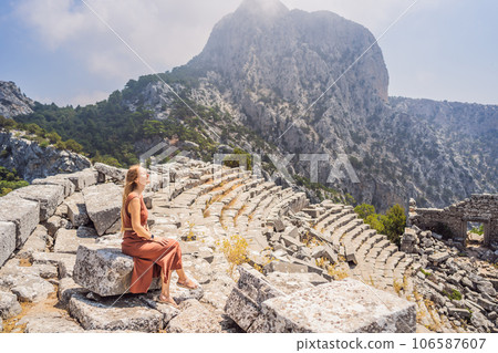 Woman tourist explores Stunning Ancient Theater of Termessos Ancient City turkiye, GO Everywhere Woman tourist explores Stunning Ancient Theater of Termessos Ancient City turkiye, GO Everywhere 106587607