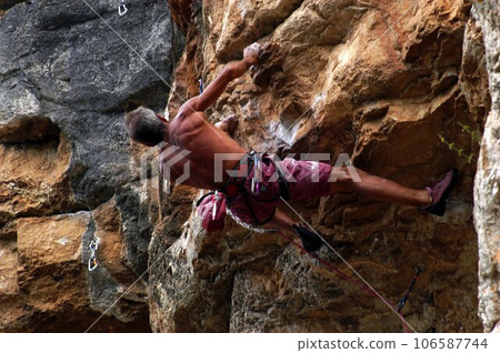 man with safety rope at sport climbing 106587744