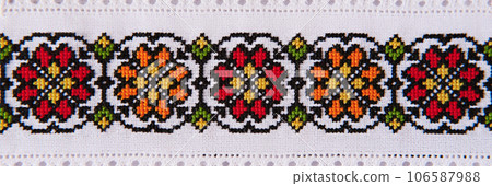 Embroidery design with colored cotton threads on white flax. Background with embroidery for banner. 106587988
