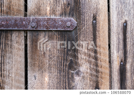 Old wooden door with rusty hinge, background. 106588070