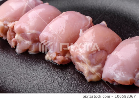 Fresh raw chicken thigh fillets with salt, spices and herbs 106588367