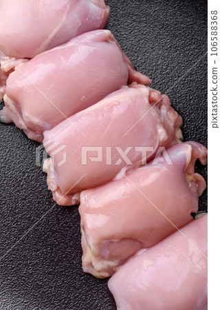 Fresh raw chicken thigh fillets with salt, spices and herbs 106588368