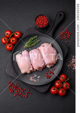 Fresh raw chicken thigh fillets with salt, spices and herbs 106588398