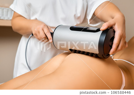 LPG hardware anti-cellulite massage in beauty salon performed by massage therapist.  106588446
