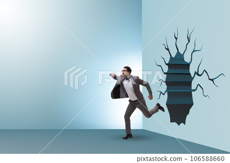 Businessman breaking through the wall Businessman breaking through the wall 106588660