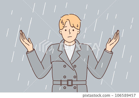 Man stands under rain and spreads arms, stressed due to lack of umbrella and roof over head 106589457