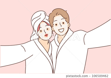 Man and woman with cosmetic masks on faces, dressed in bathrobes to perform SPA treatments Man and woman with cosmetic masks on faces, dressed in bathrobes to perform SPA treatments 106589462