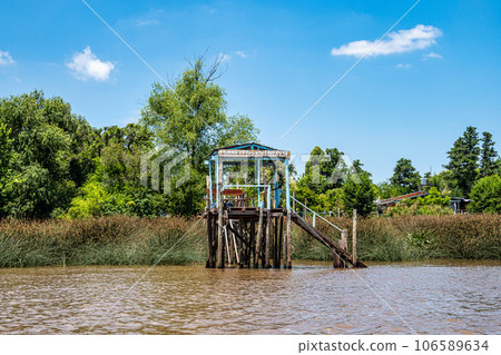 Boat tour on the Parana Delta, Tigre, Buenos Aires, Argentina. Palm trees, construction site of modern brick house. 106589634