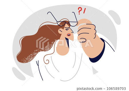 Confused woman puts on glasses to see small detail, due to vision problems and need for eye surgery Confused woman puts on glasses to see small detail, due to vision problems and need for eye surgery 106589703